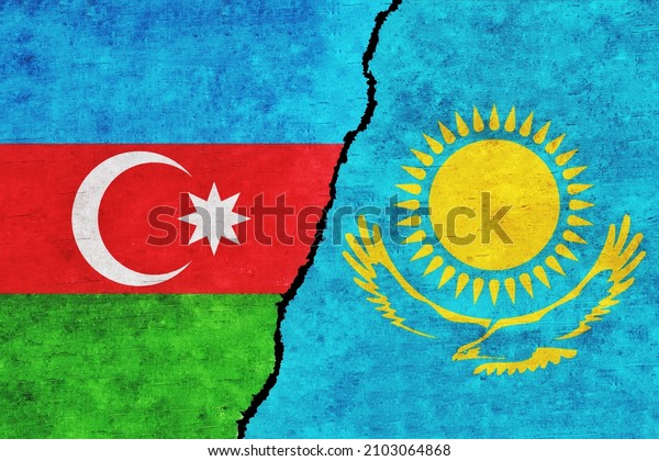Azerbaijan and Kazakhstan painted flags on a\
wall with a crack. Azerbaijan and Kazakhstan relations. Kazakhstan\
and Azerbaijan flags\
together
