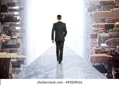 Back View Of Businessman In Suit Walking On Concrete Walkway. Abstract Rotated City Background. Success Concept