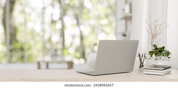 A back view image of a laptop computer, books, and decors on a wooden desk in a minimalist bright living room. Home workspace concept. 3d render, 3d illustration