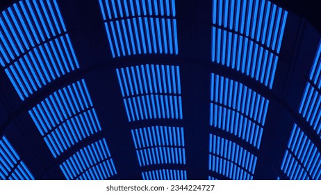 A background of an Elegant and Modern 3D Rendering image in blue and black looking up at cylinder LED electric bulletin board. High quality 3d illustration