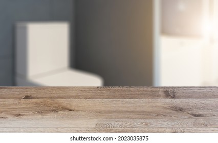 Background with empty wooden table. Flooring. Freestanding bath with towels in grey modern bathroom. 3D rendering.. Sunset. - Shutterstock ID 2023035875