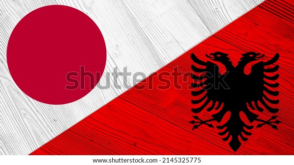 Background with flag of Japan and Albania on\
divided wooden board. 3d\
illustration