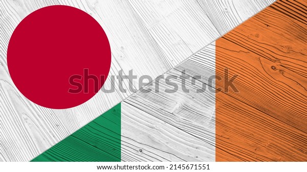 Background with flag of Japan and Ireland on\
divided wooden board. 3d\
illustration