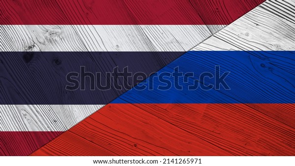 Background with Thailand and Russia flag on\
divided wooden board. 3d\
illustration