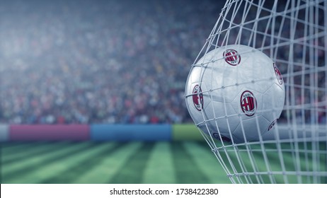 Ball With AC Milan Football Club Logo Hits Football Goal Net. Conceptual Editorial 3D Rendering