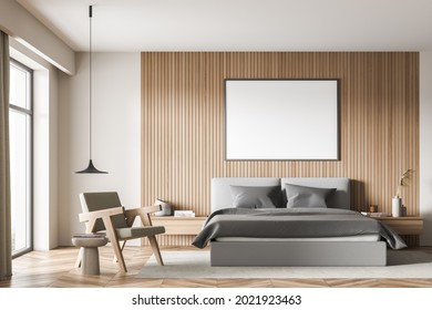 Banner In The Bedroom Interior With Grey Bed, Wall Panelling, Armchair With Coffee Table, Rug, Accent Pendant Lamp, Parquet And Light Beige Walls. A Concept Of Modern House Design. 3d Rendering