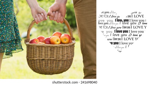 Basket of apples being carried by a young couple against valentines day pattern - Powered by Shutterstock