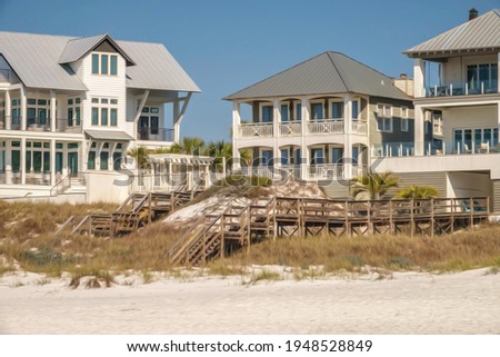 Beach view of small grassy dune between elevated boardwalks near multistory several houses along the Gulf Coast of the Florida Panhandle, with digital oil-painting effect. 3D rendering.