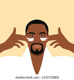 Bearded african man in a white bathrobe applies cream to his face. Daily skin care routine  - Powered by Shutterstock