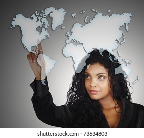 beautiful African AMerican businesswoman pointing at the North America on the drawing of the map of the world with a positive attitude. - Powered by Shutterstock