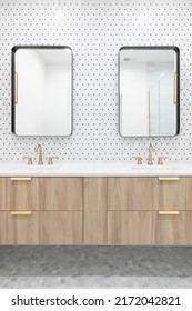 A Beautiful Bathroom With A Floating Wood Vanity Cabinet, Gold Faucet And Lights, Mosaic Tile Wall, And Rectangular Mirrors.