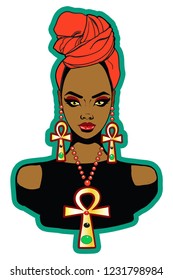 Beautiful black woman with headwrap large Ankh necklace and Ankh earrings.