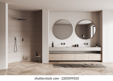 Beige Bathroom Interior With Double Sink And Round Mirror, Foot Towel On Hardwood Floor. Shower And Stool With Bath Accessories. 3D Rendering