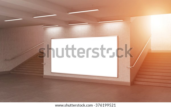 A big blank horizontal
billboard in the underground, stairs up on both sides. Grey walls.
Side view. Filter. Concept of underground advertising. 3D
rendering