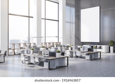 Big blank white poster in black frame on grey wall in open space office with high ceiling, modern furniture and huge windows. Mock up. 3D rendering
