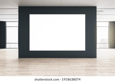 Big blank white poster on black wall in the center of empty eco style hall with big windows and wooden floor. Mockup. 3D rendering