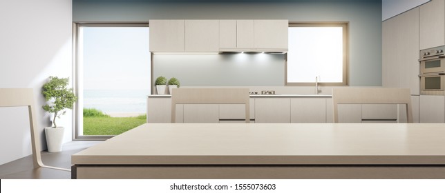 Big Glass Window Near Counter And Cabinet Of Modern Sea View Kitchen In Luxury Summer Beach House. Dining Room 3d Rendering For Product Display Mock Up On Empty Clean Wooden Top Table.