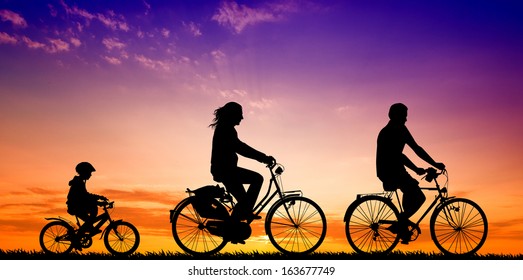 Biking Family At Sunset