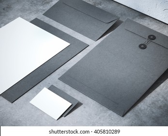Black branding mockup on a concrete floor with shadows. 3d rendering