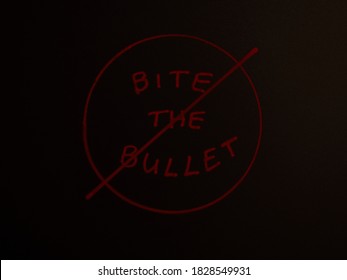 Black Chalkboard With Bite The Bullet Written In Red With A Circle Around It And Slash Or Line Through It.