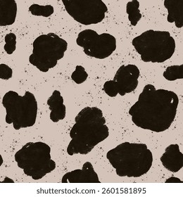 Black and cream cow print pattern with abstract splotches on a textured background