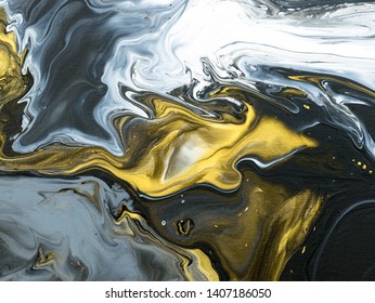 Black and gold creative abstract hand painted background, marble texture, fragment of acrylic painting on canvas. Modern art. Contemporary art.