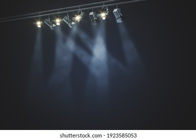 Black rail with spotlights and beams of light in the smoke at dark background. 3D rendering