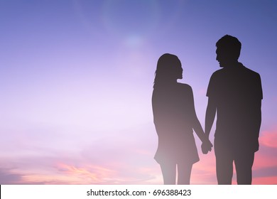 black silhouette of couples lover holding hand and looking each other on blurred beautiful sunset sky in honeymoon moment,just married concept - Powered by Shutterstock