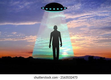 Black Silhouette Of Ufo Spaceship, Man, Earthling In Rays Of Light, Dramatic, Disturbing Situation, Concept Aliens Arrived On Flying Saucer, Mysterious Disappearance Of People, Paranormal Phenomena