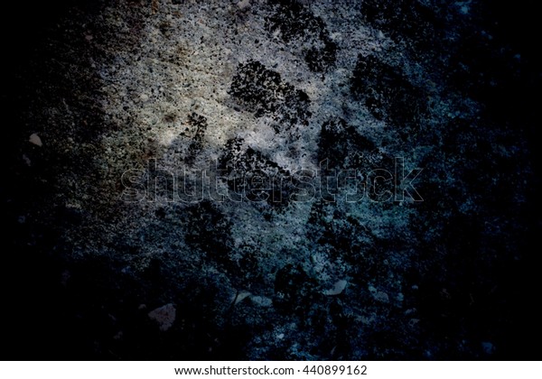 Black spots on a dark blue concrete wall.\
Grunge texture. Dark gloomy\
background.