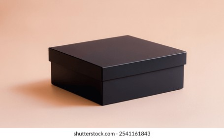 Black square box on a light tan background with a slight shadow cast. Premium packaging box mockup for displaying a marketing advertisement for a product.