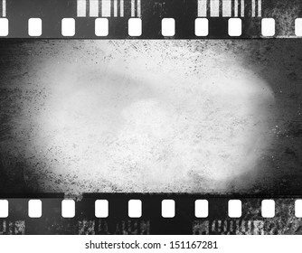 A black and white grunge film frame with white empty space inside