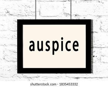 Black Wooden Frame With Inscription Auspice Hanging On White Brick Wall 