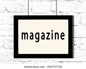 Black Wooden Frame With Inscription Magazine Hanging On White Brick Wall 