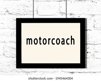 Black Wooden Frame With Inscription Motorcoach Hanging On White Brick Wall 