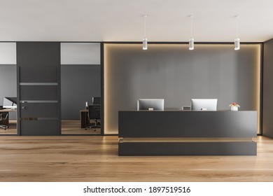 Black And Wooden Reception Room With Two Computers, Conference Office Room. Black Wall With Backlight, Reception Entrance, Front View, Parquet Floor 3D Rendering, No People