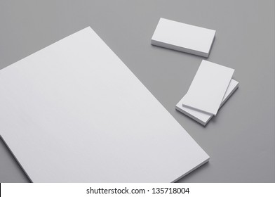 Blank A4 Print Paper And Business Cards Isolated On Grey Background With Soft Shadows / Stationary