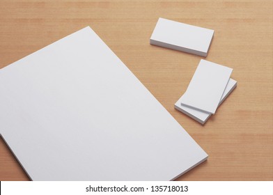 Blank A4 Print Paper And Business Cards On Wooden Background / Stationary