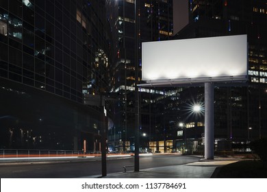 Blank Billboard At Night Time During Twilight With The City On Background. 3d Rendering