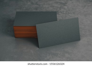 Blank black business card standing on black table. 3D Rendering - Powered by Shutterstock