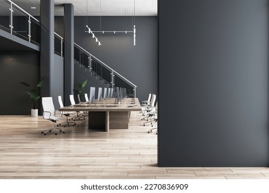 Blank black partition with place for advertising poster or logo in modern interior design spacious office hall with conference table, wooden floor and dark wall background. 3D rendering, mock up