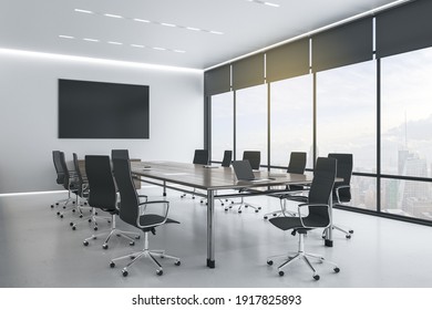 Blank black tv screen on white wall in modern conference room with stylish furniture and city view. Mockup. 3D rendering