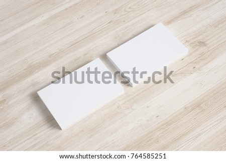 Blank business cards stack on wooden desk. 3d render.