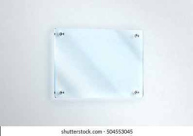 Blank Glass Nameplate Mounted On The Wall Mockup, Clipping Path, 3d Rendering. Clear Acrylic Sign Frame Design Mock Up. Empty Shiny Mirror Holder Fixed On White Wall. Office Door Glassy Signage.