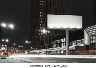 Blank Illuminated Billboard Near Well-lit Road At Night Time In The City. 3d Rendering