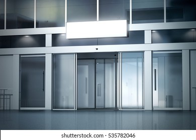 Blank light box on the store with opened automatic glass doors entrance mockup, 3d rendering. Commercial nightly business center entry, sign board mock up. Opened illuminated facade, front view.