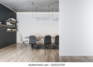 Blank Light Grey Wall With Empty Place In Modern Meeting Room With Bookshelves On Dark Wall, Stylish Conference Table Surrounded By Chairs On Wooden Floor And Concrete Ceiling. 3D Rendering, Mockup