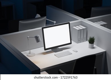 Blank Mock Up Computer Screen Standing On White Table In Office Cubicle At Night. Concept Of Advertising And Product Placement. 3d Rendering