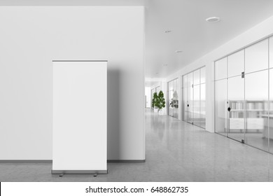 Blank Roll Up Banner Stand In Bright Office Interior With Clipping Path Around Ad Stand. 3d Illustration