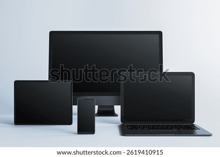 Blank screen mockup of desktop computer, laptop, tablet, and smartphone in clean layout on light background, concept of digital device presentation. 3D Rendering